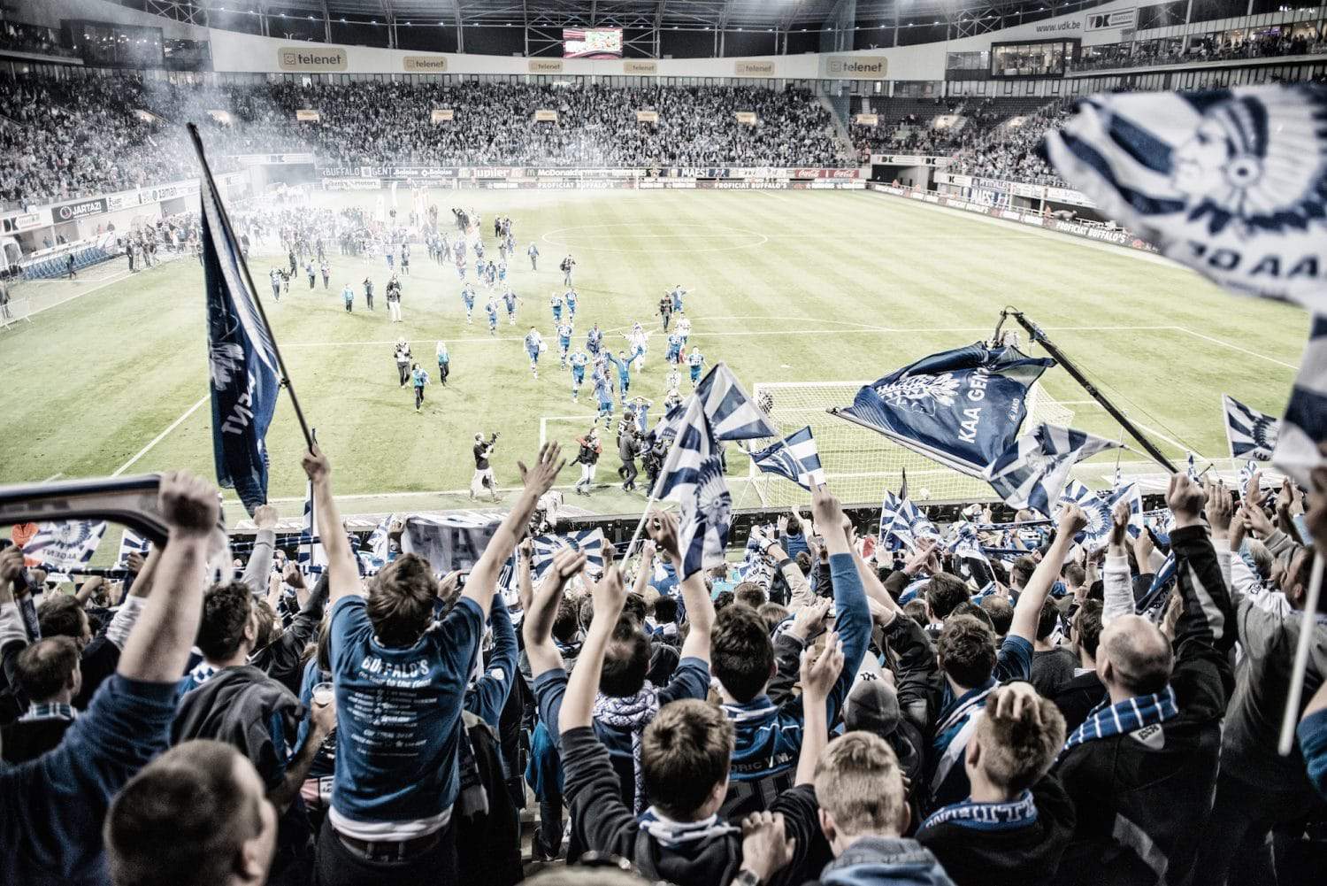 Fans celebrating in a football stadium